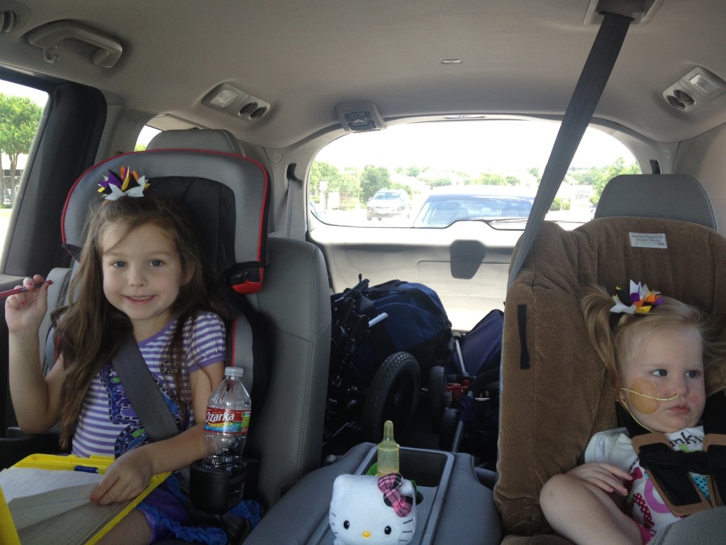 two children in the riding in the minivan